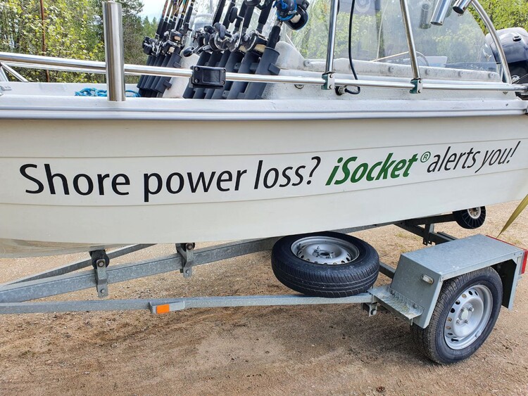 Spare wheel installed on the boat trailer with the boat